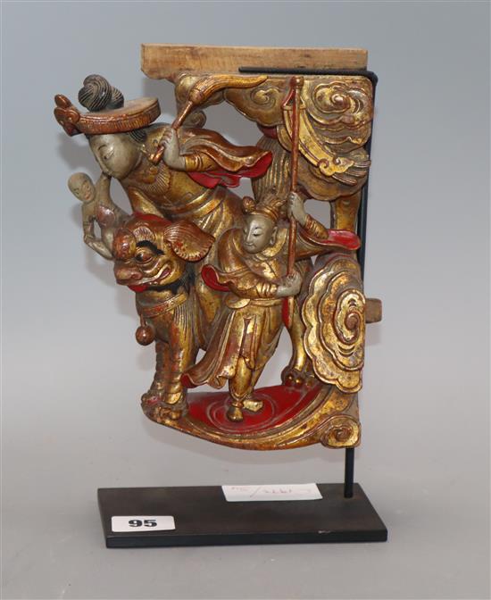 A Chinese gilt and red lacquered carving of figures, on stand length 20cm excl. stand